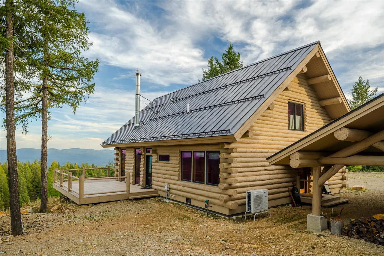 Salish Ridge exterior with deck and metal roof, Meadowlark Log Homes
