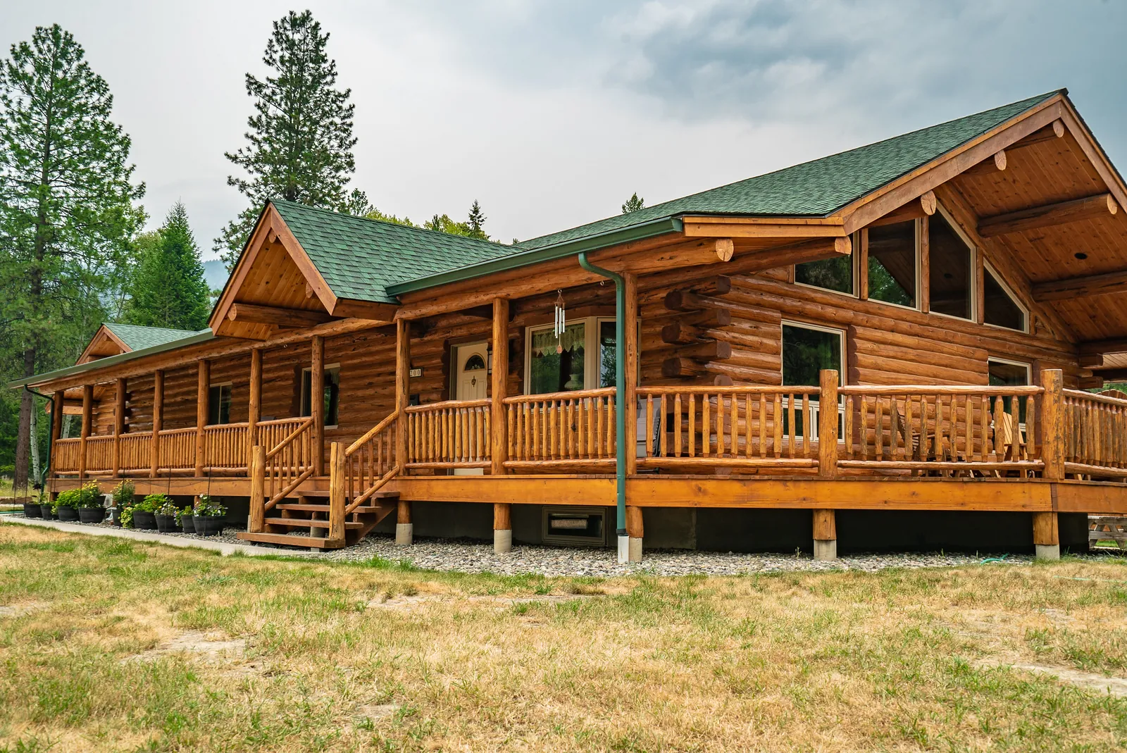 Montana log home with green roof and covered porch