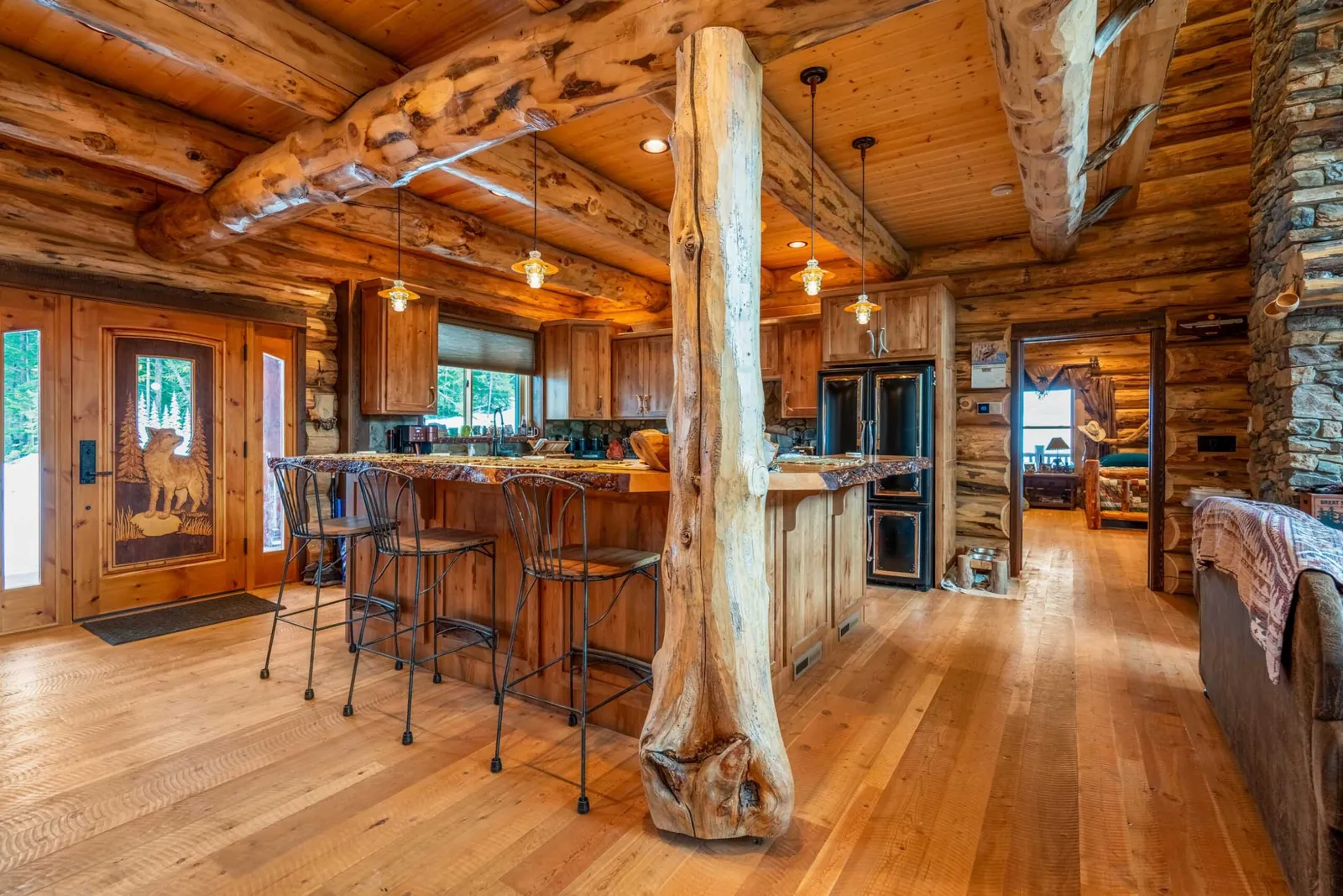 Log home kitchen with hand-peeled log posts