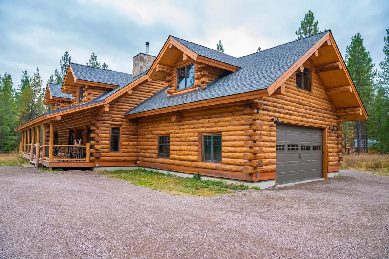 Silverwolf exterior with dormers and attached garage, Meadowlark Log Homes