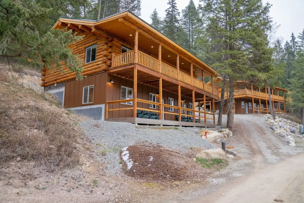 Meadowlark Rancher hillside exterior with covered decks, Meadowlark Log Homes