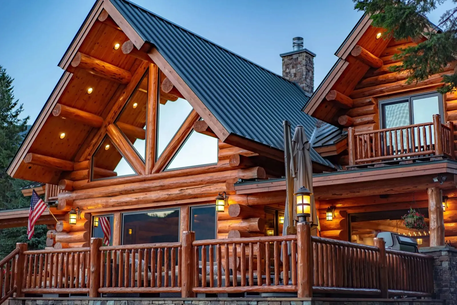 Log home exterior with metal roof and lanterns