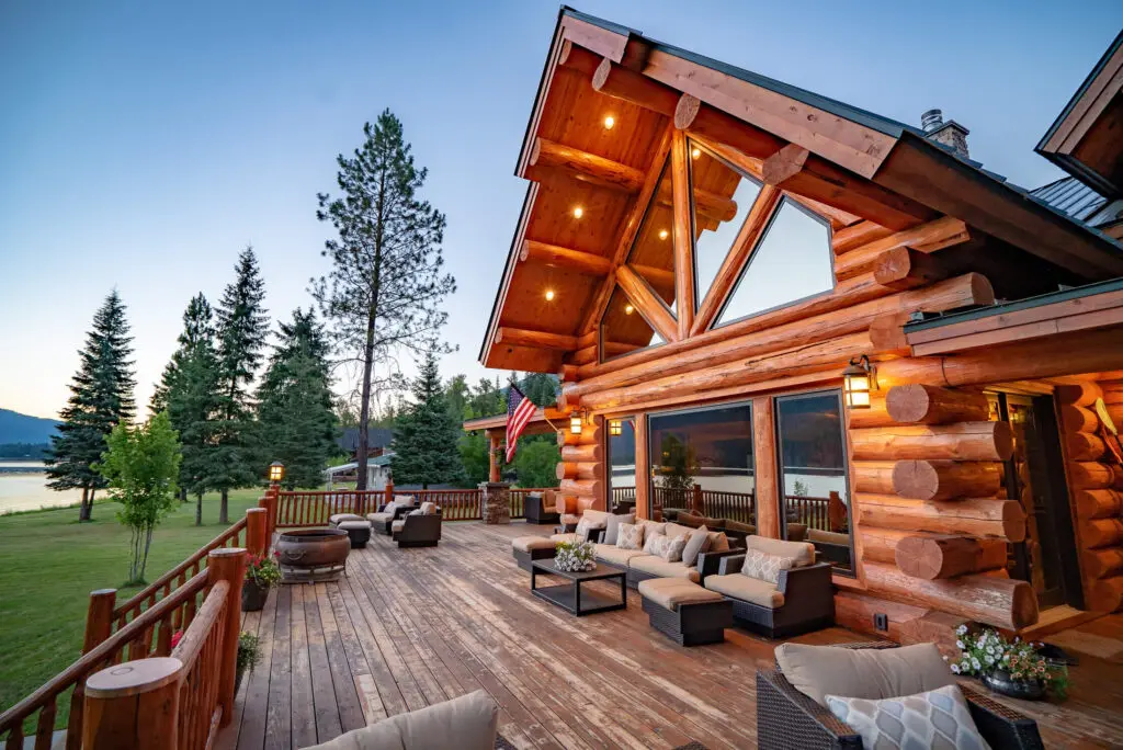 Stunning log cabin with deck and scenic mountain view at sunset