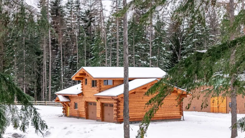 Cozy log cabin surrounded by snowy forest landscape