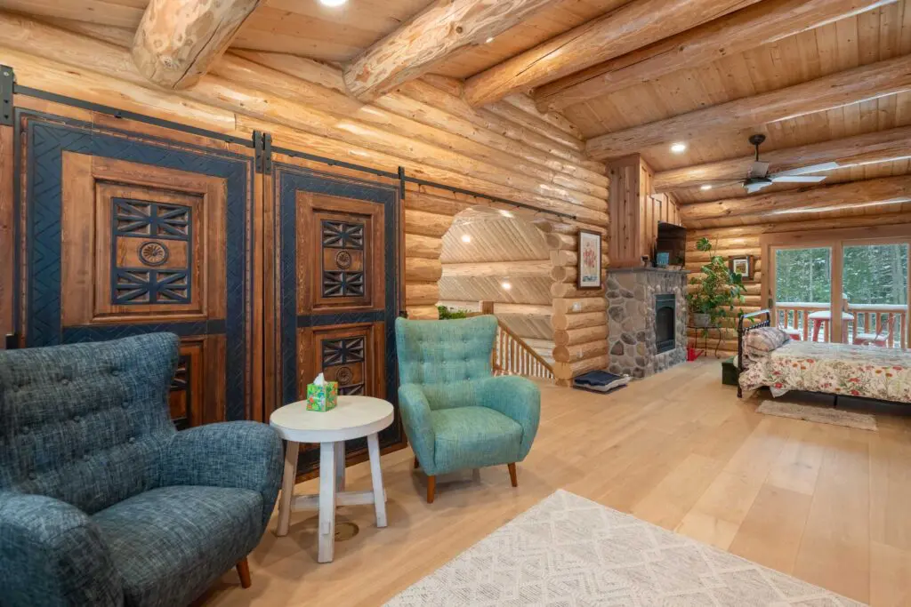 Rustic log cabin interior with cozy chairs and wooden decor