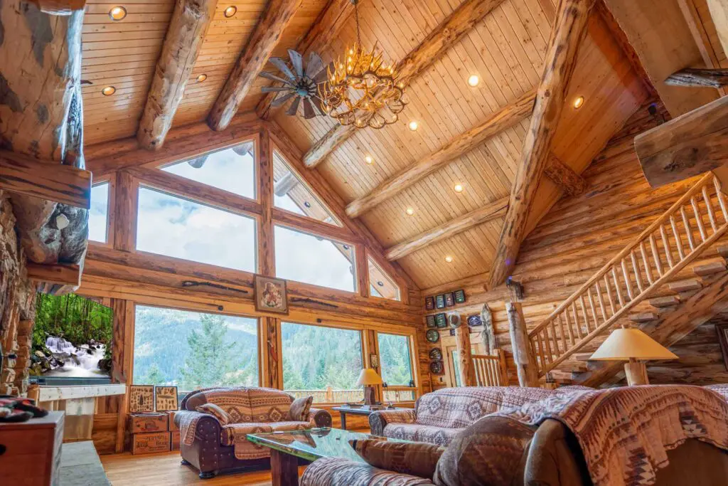Rustic log cabin interior with vaulted ceilings and mountain view