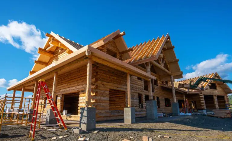 Wooden house under construction with clear blue sky background